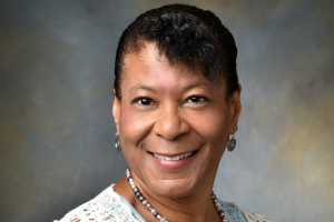 Portrait of behavioral health clinician Margaret Clarke wearing white and blue clothing